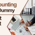 A focused man working at a desk, reviewing documents labeled "Accounting for Dummies Cheat Sheet"