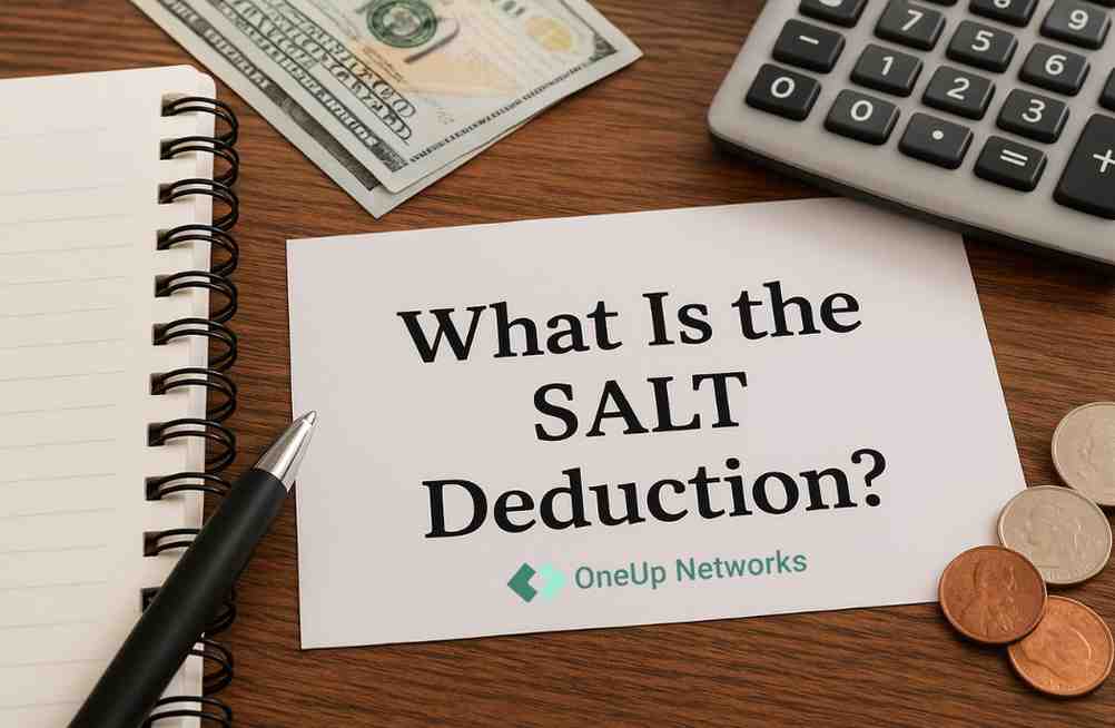 A financial workspace with a notepad, pen, calculator, cash, and coins on a wooden desk. A paper reads “What Is the SALT Deduction?” with a oneupnetworks logo visible in the bottom right corner.