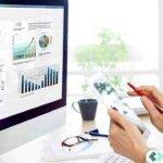 Professional CPA working on a laptop in a modern office environment, using AI-powered tax preparation and cloud hosting technology to reduce audit risks.