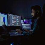 IT professional working on a secure cloud system at night with code overlays, illustrating how Citrix improves performance and eliminates RDP lag for hosting Accounting CS in CPA firms.