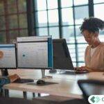 Accounting professionals working on desktop computers in a modern office environment representing scalable cloud technology for CPA firms