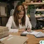 finance professional handling accounting documents and secure cloud workflows