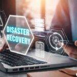 Disaster recovery concept displayed on laptop with cloud backup icons and OneUp Networks logo in a modern office